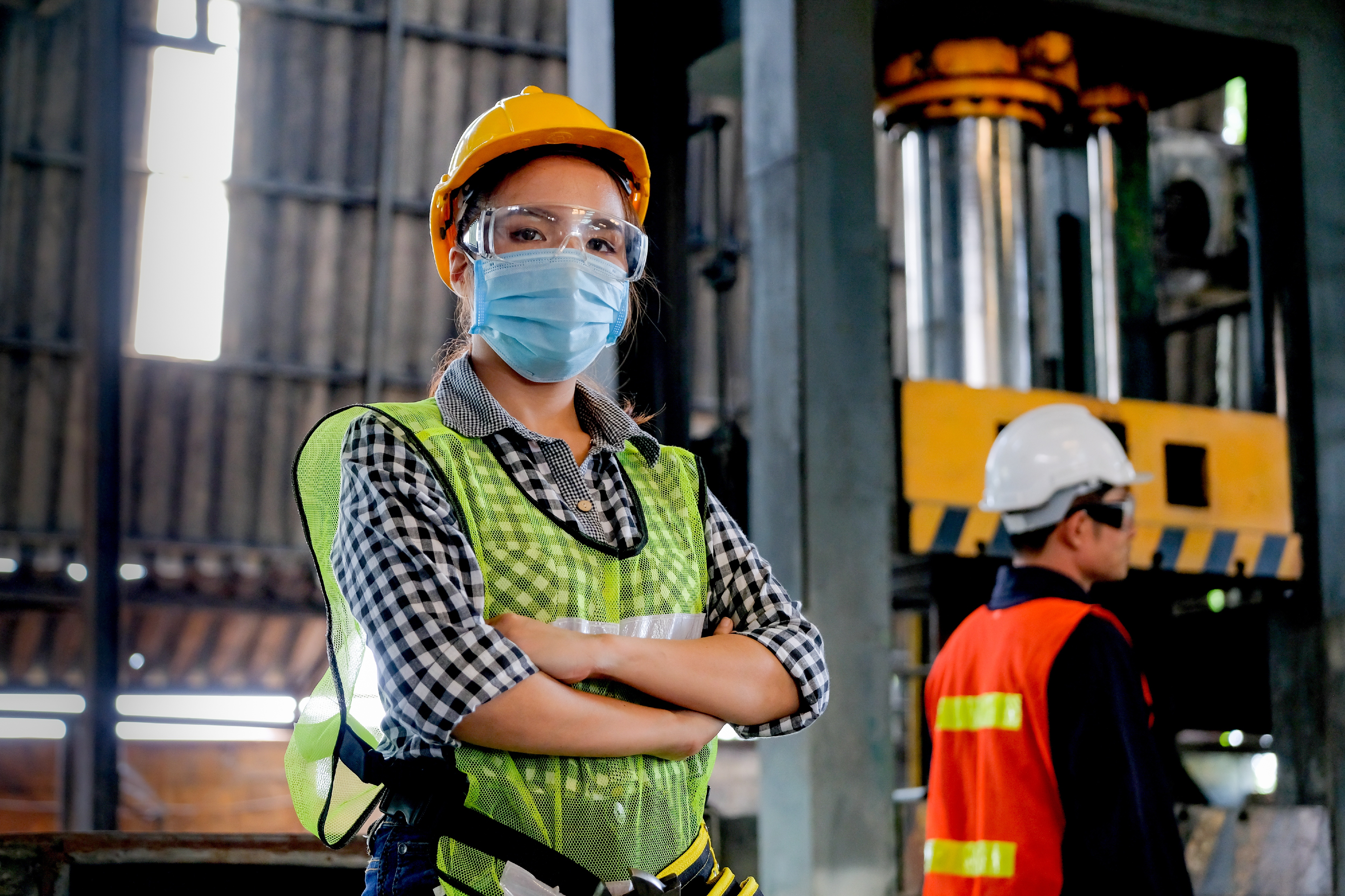 Worker in a factory with mask